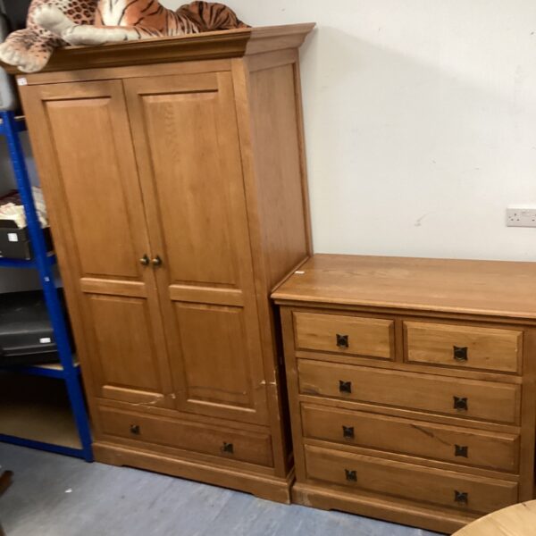 Vintage oak wardrobe and chest of drawers for bedroom storage.
