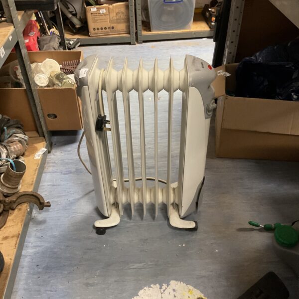 White compact oil-filled radiator heater for portable heating.
