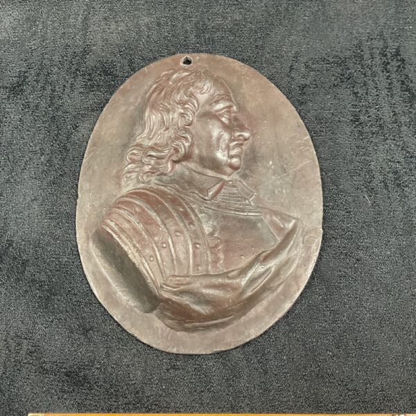 Bronze relief plaque depicting Oliver Cromwell in profile.