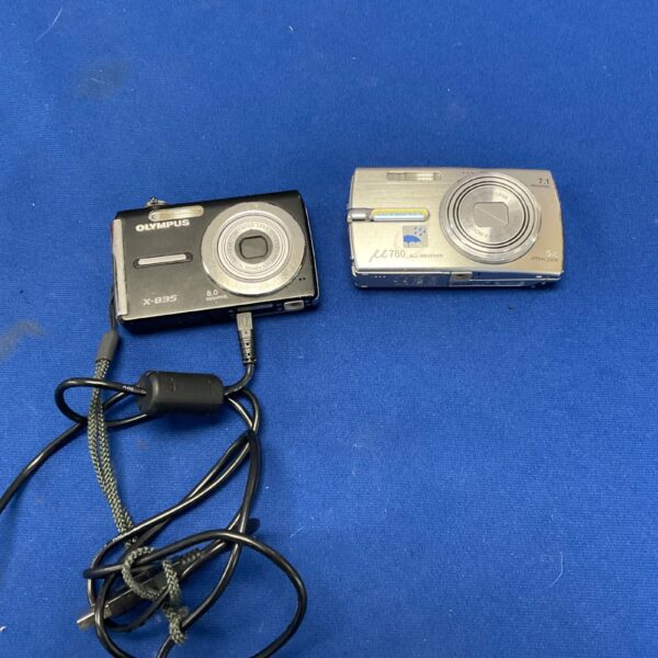 Silver Olympus M780 digital camera with charger.