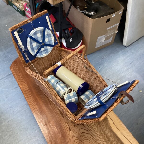 Vintage Optima picnic basket with contents for outdoor dining.