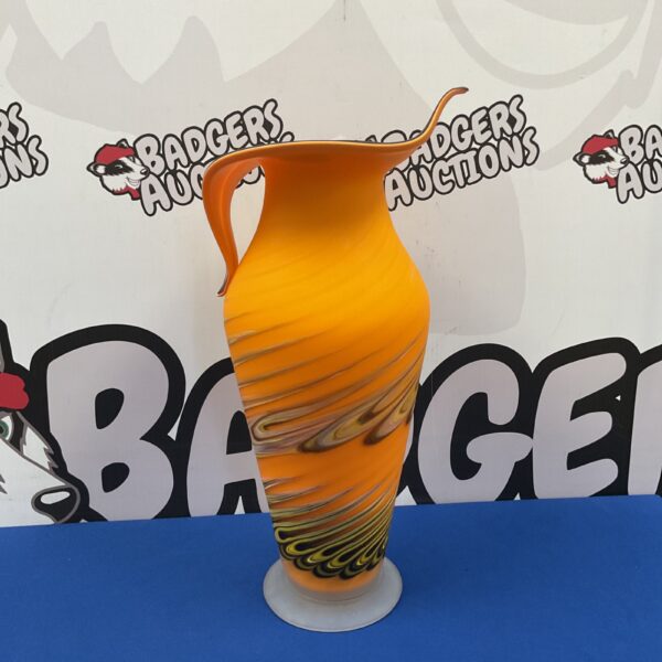 Vibrant orange art glass vase with tulip shape.