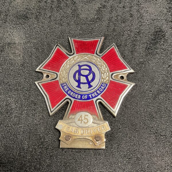 Vintage Order of the Road car badge with red enamel.