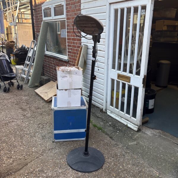 Used outdoor patio heater in a garden setting.