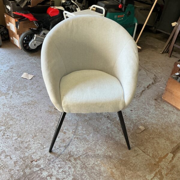 Neutral padded occasional chair with tapered legs.