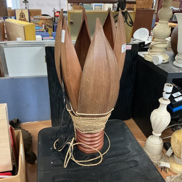 Vintage palm leaf lamp with rattan base and woven leaves.