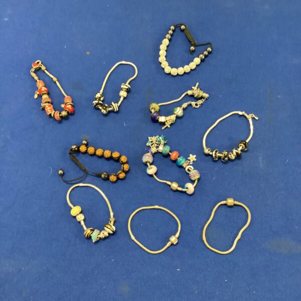 Mixed lot of colourful Pandora style charm bracelets.