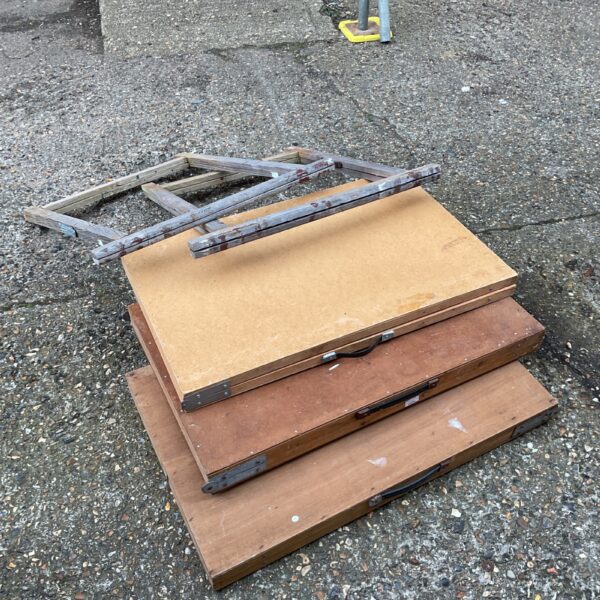 Vintage pasting tables and trestles in a workshop setting.