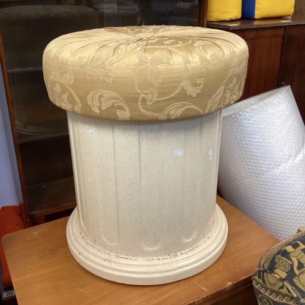 Vintage pillar stool with patterned cushioned seat.