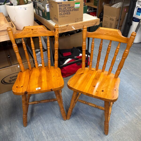 Pair of rustic pine farmhouse chairs with turned spindles.