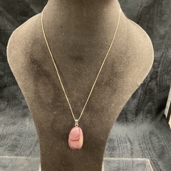 Pink agate pendant necklace on silver chain.
