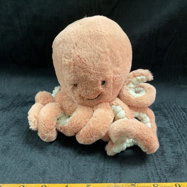 Pink Jellycat octopus plush toy, soft and cuddly.