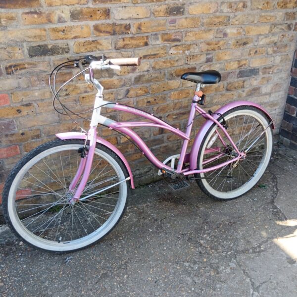 Pink Snob Cruiser ladies bicycle with whitewall tires.