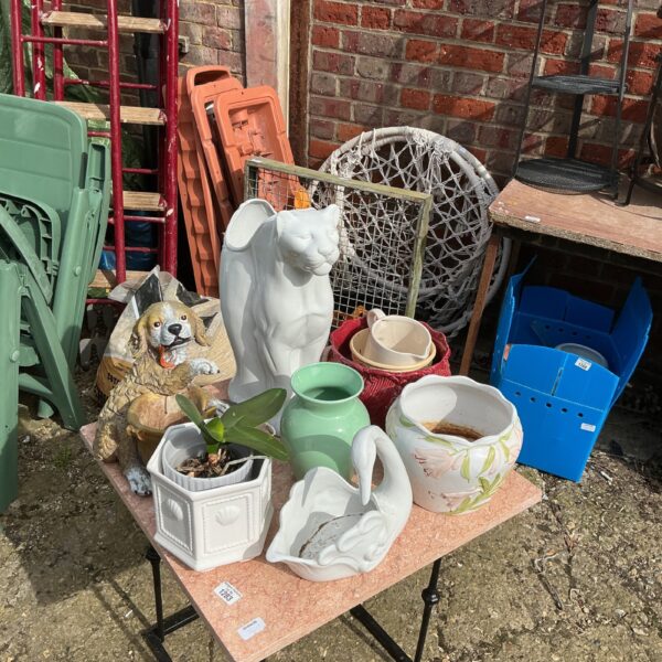 Collection of vintage plant pots and garden ornaments.