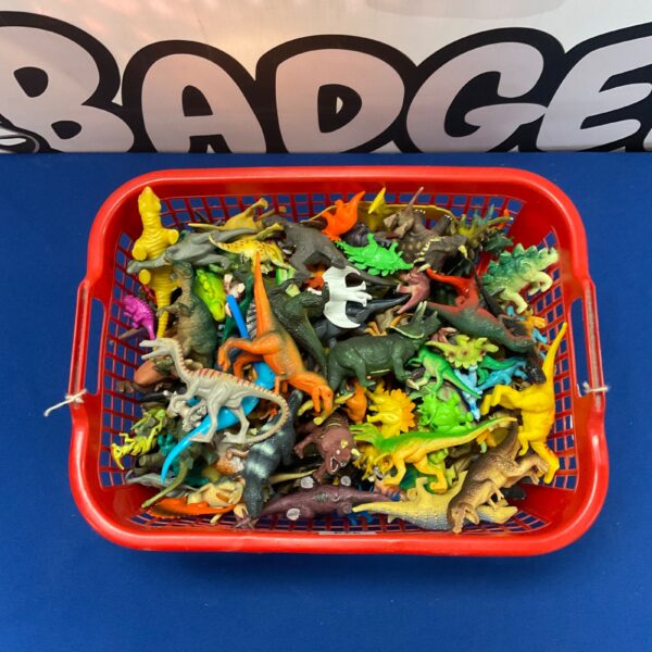 Bulk lot of colourful plastic dinosaur figures for collectors.