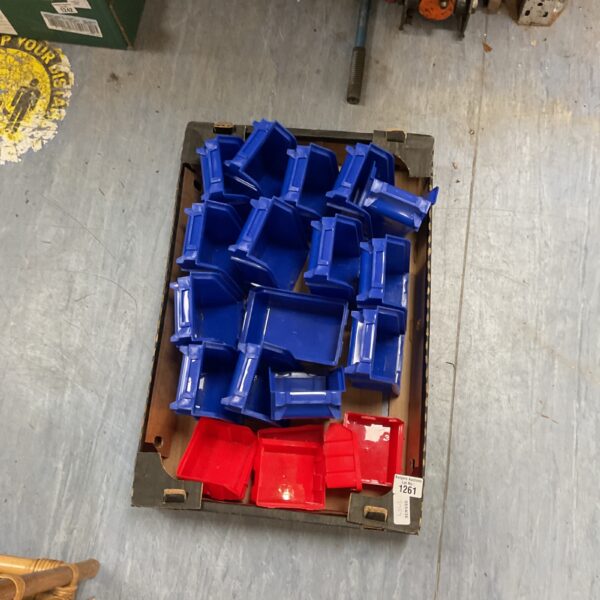 Stack of blue plastic storage bins for parts organisation.