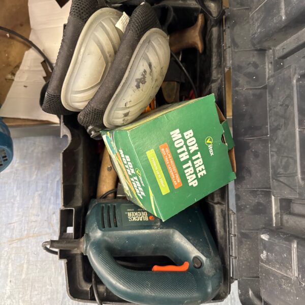 Vintage plastic toolbox filled with assorted tools and garden items.