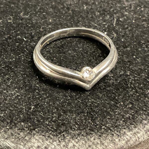 Close-up of a platignum diamond wishbone ring.
