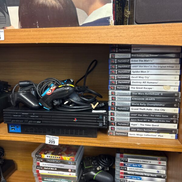 Vintage Sony PlayStation 2 console with game lot.