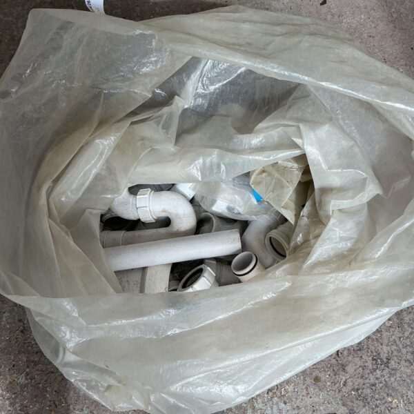 Assorted plumbing connector joints in a plastic bag.