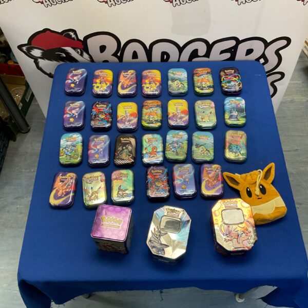 Lot of empty Pokémon trading card tins for collectors.
