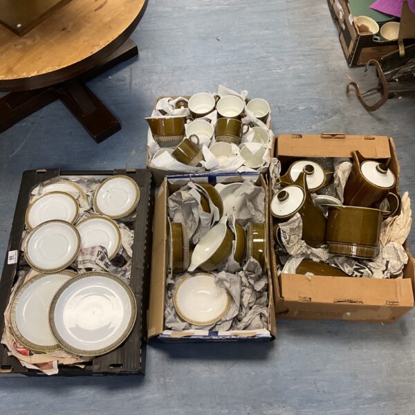 Poole Pottery dinner service overview with brown glazed pieces.