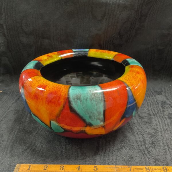 Vibrant vintage Poole Pottery mosaic bowl with bold colours.