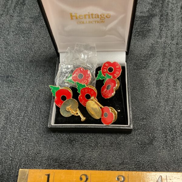 Remembrance Day poppy pin badges and cufflinks set for collectors.