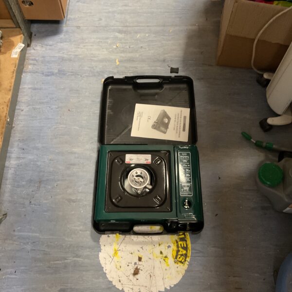Portable butane gas stove with carrying case for outdoor cooking.