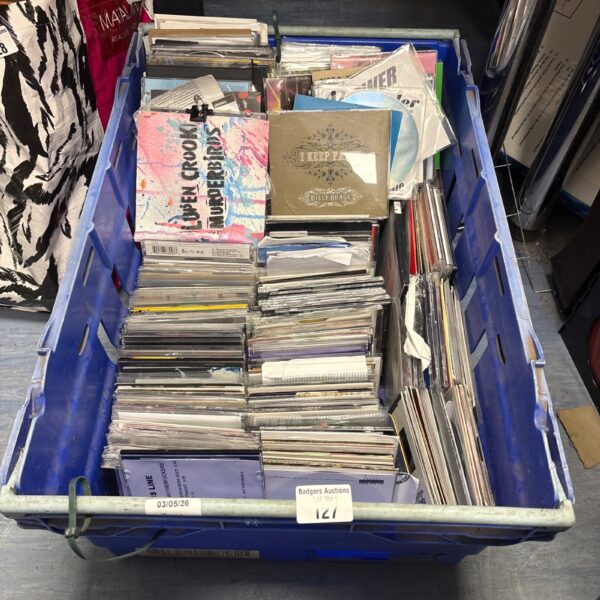 Large lot of promotional CDs in a blue bin.