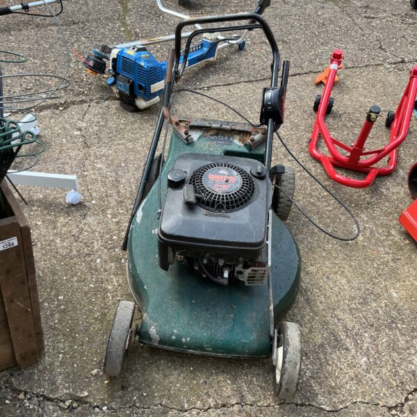 Front view of a Quantum petrol lawnmower needing repair.