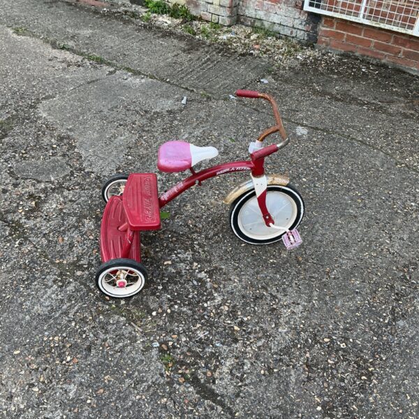 Vintage red Radio Flyer tricycle, a classic childhood toy.