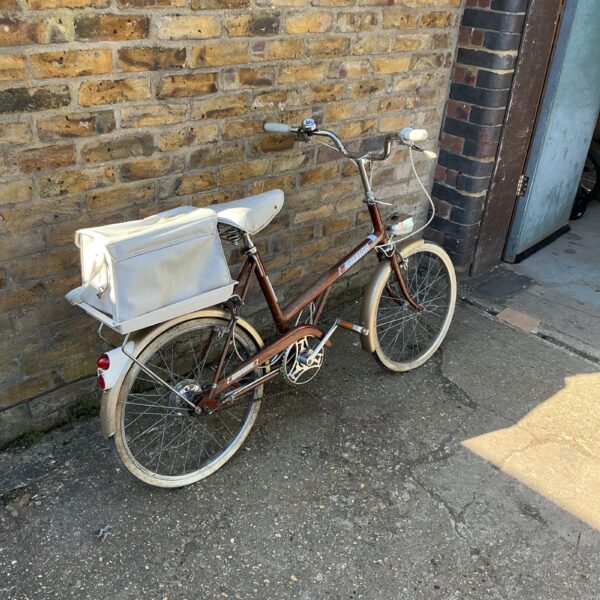 Vintage Raleigh shopper bicycle with front basket, classic British design.