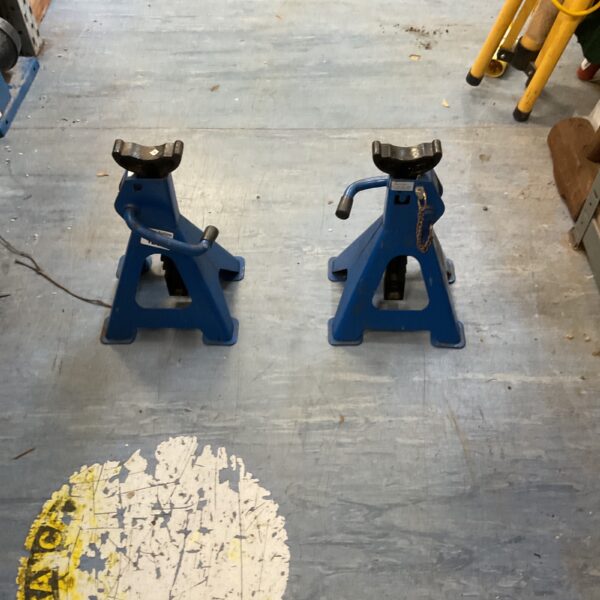 Pair of heavy-duty ratchet axle stands for automotive work.