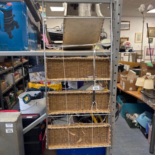 Woven rattan door hanging shelf unit with four tiers.