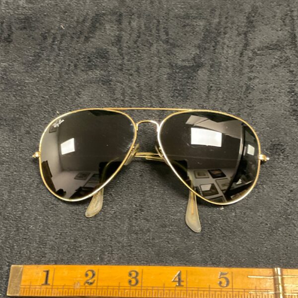 Vintage Ray-Ban Aviator sunglasses with gold frame and dark lenses.
