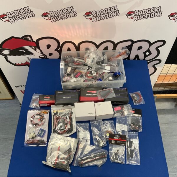 RC car parts lot including Rocket Surpass Nobby brushless power system components.