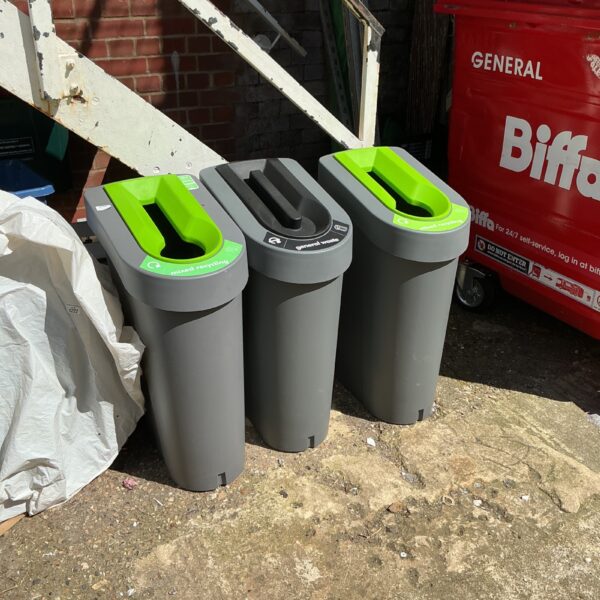Set of three plastic recycling bins for garden waste separation.