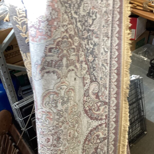 Vintage red floral rug with intricate pattern.