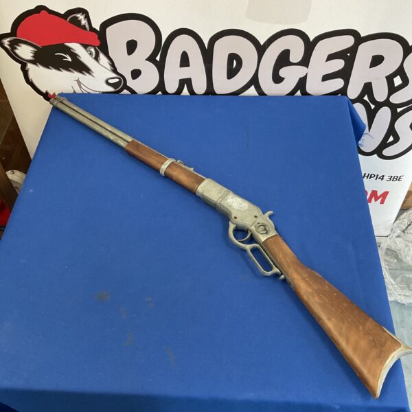Detailed view of a replica Winchester rifle prop.