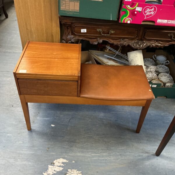 Vintage teak telephone table with drawer in a hallway setting.
