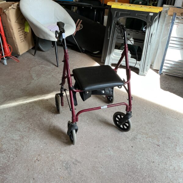 Rolling walker with padded seat for senior mobility assistance.