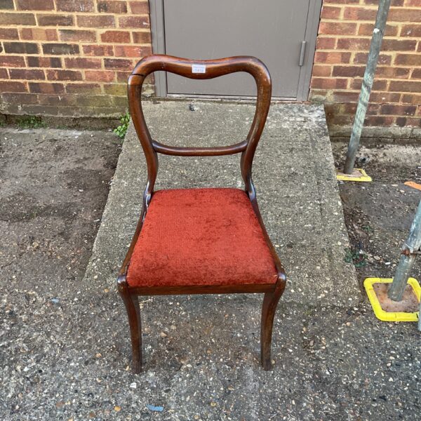 Antique rosewood balloon back chair with a curved design.