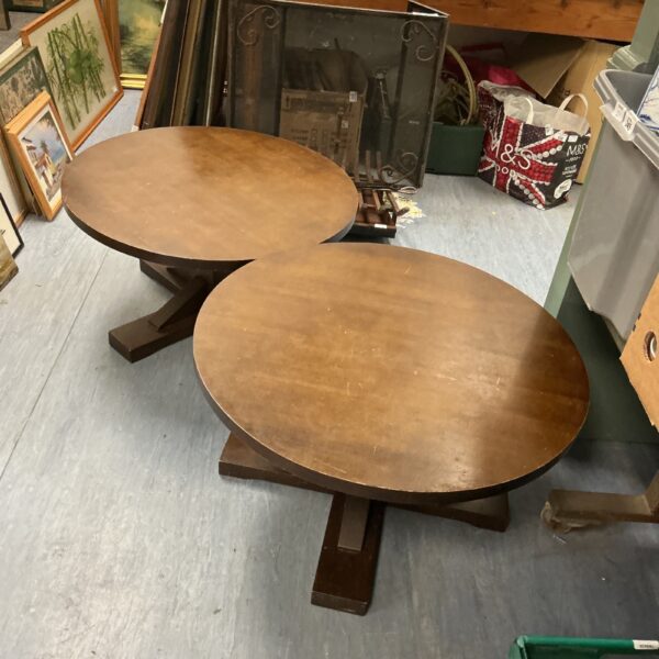 Vintage round coffee table with a wooden top and simple design.