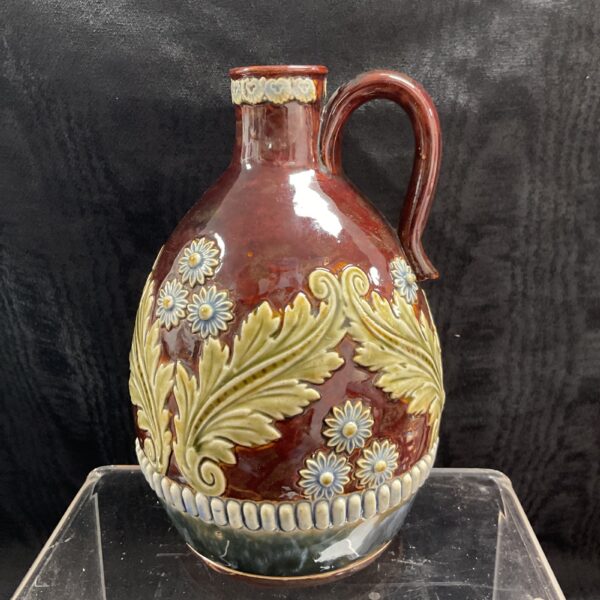 Antique Royal Doulton stoneware flask with embossed floral design.