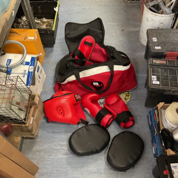 Red Rupla Industries boxing sparring set with head guard and gloves.