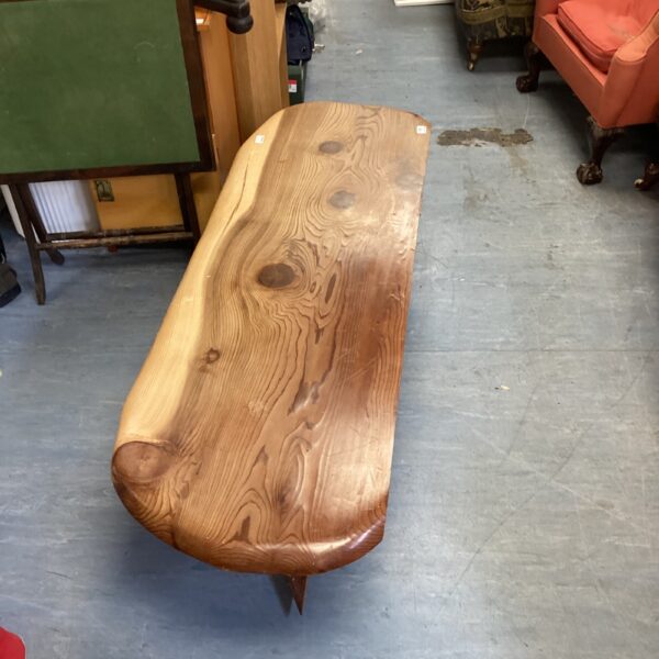 Large rustic pine coffee table with a natural live edge.