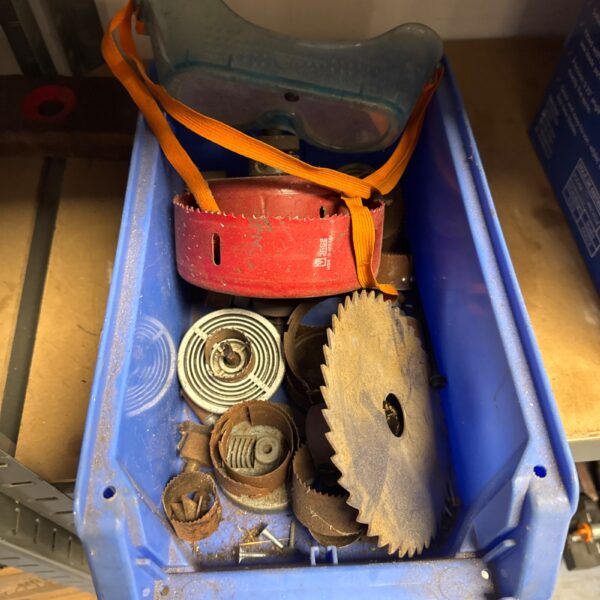 Tray of assorted used saw blades for workshop tasks.