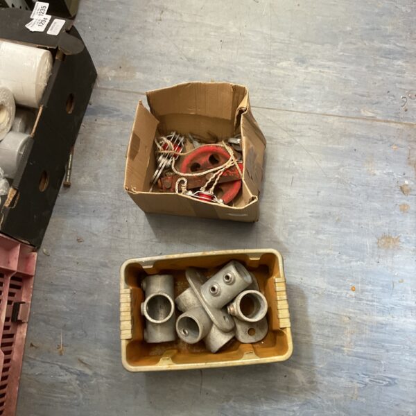 Lot of used steel scaffolding fittings for construction projects.