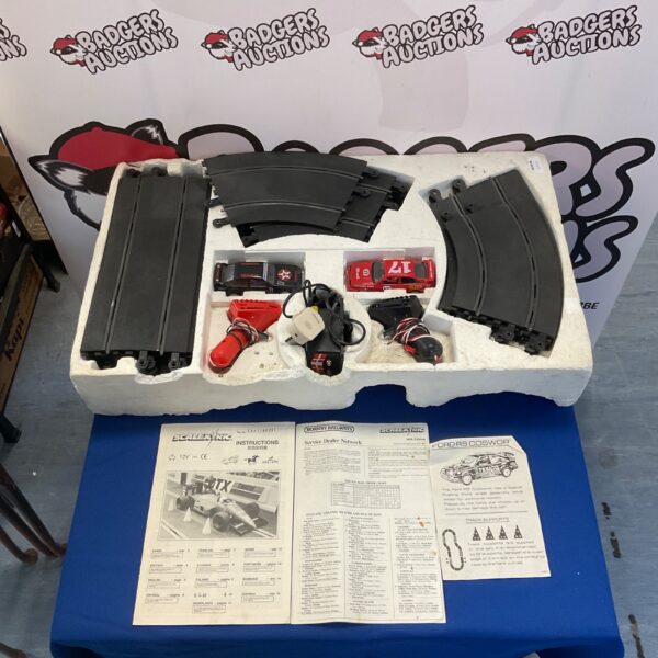Vintage Scalextric Ford RS Cosworth racing set with track and controllers.